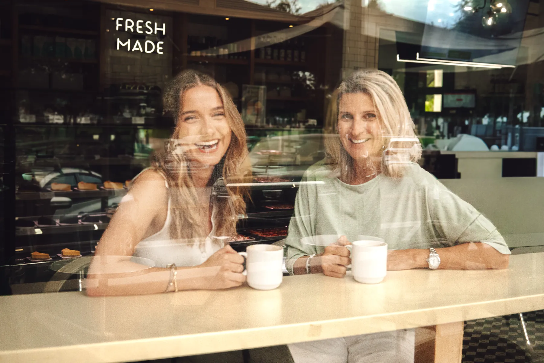 Madisyn and Dr Kidgell sharing coffee together at a café